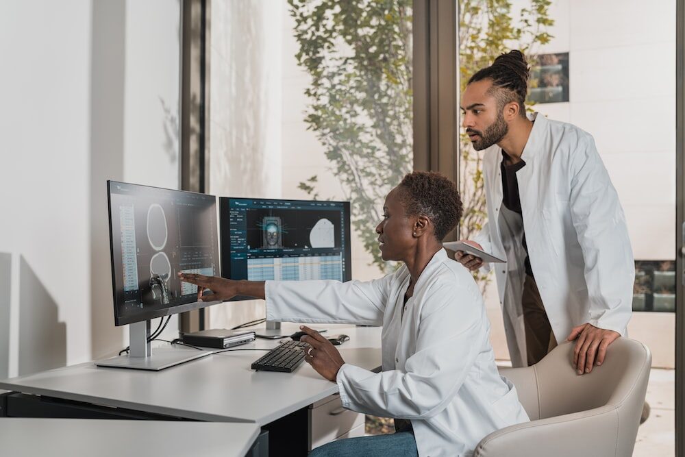 a doctor is looking at scans on a computer